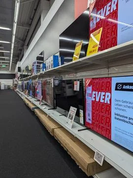 Organized television display section in electronics store interior side view. Stock-Fotos