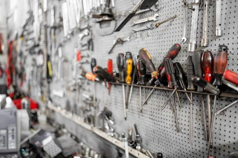 Organized wall of hand tools in professional workshop or garage Photos