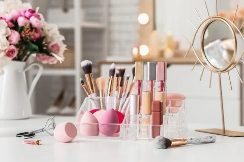 Organizer with makeup products on table in dressing room Stock Photos