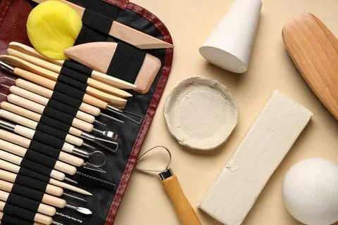 Organizer pouch with set of different sculptor tools, clay plate and plaster  Stock Photos
