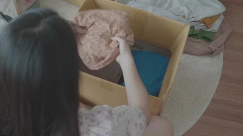 Organizing and Sorting Clothes in a Box Stock Footage 315975117