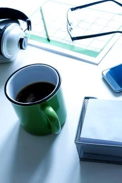 Organizing appointments in the calendar meanwhile drinking a cup of coffee Stock Photos