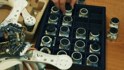 Organizing broken drone's cameras in box. Close up. 4K. Stock Footage 86914493