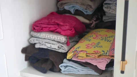 Organizing clothes in a cupboard at home Stock Footage 337810250