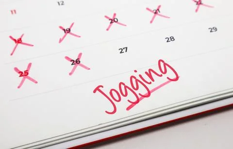 Organizing an exercise schedule and marking off successful jogging days on .. Stock Photos