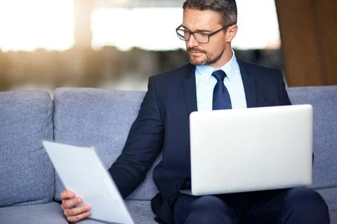 Organizing his work day with the ease of wireless technology. a businessman Stock Photos