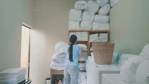 Organizing Laundry in a Bright Room Stock Footage 314786819