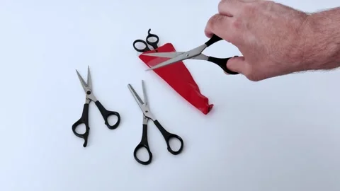 Organizing Scissors on Table with Red Case and Human Hand Interaction Video stock 311974363