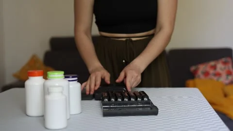 Organizing weekly pills at home Video stock 339096239