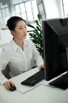 Oriental 20 to 30. Computer Keyboard Shirt Work Oriental figures Business Stock Photos