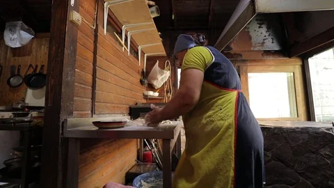 Oriental bread is cooked in tandoor. Closeup the dough on the walls of the oven Stock Footage 123368490