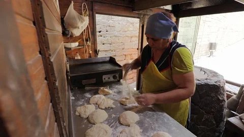 Oriental bread is cooked in tandoor. Closeup the dough on the walls of the oven Stock Footage 123368525