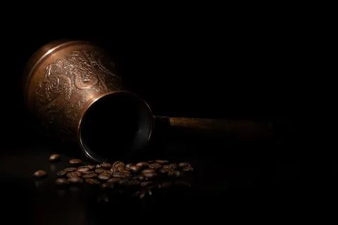 Oriental coffee maker with coffee beans. Stock Photos