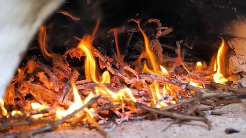 In oriental courtyard, a fire burns in a medieval stove. Hearthstone. close-up Video stock 125516545
