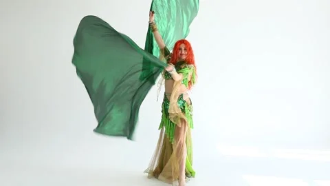 An oriental dancer with fans in a studio Видео 317913534