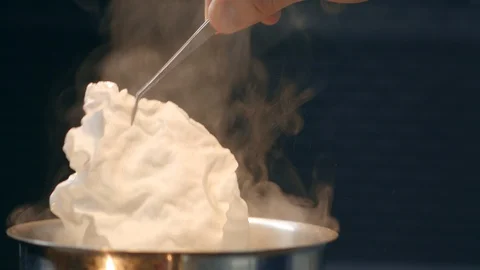Oriental fried prawn crisps Deep Fry Prawn Crackers in oil in a frying pan Stock Footage 129482360