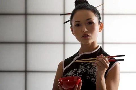 Oriental girl with chopstick Stock Photos