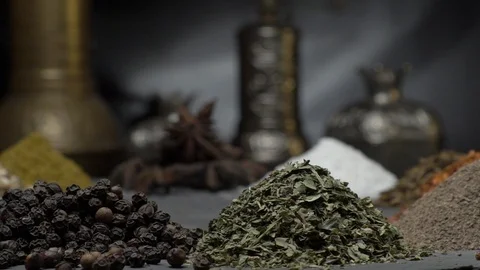 Oriental spices on a dark background move on a steep surface Stock-Footage 123561393
