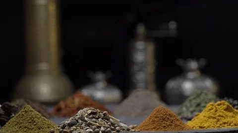 Oriental spices on a dark background move on a steep surface Stock Footage 123561513