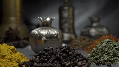 Oriental spices on a dark background move on a steep surface Stock Footage 146938227