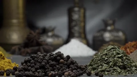 Oriental spices on a dark background move on a steep surface Stock Footage 146938274