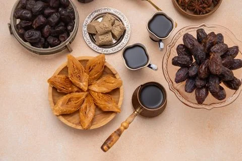 Oriental sweets and coffee on the table. Baklava, halva, Dates fruit for dess Foto stock