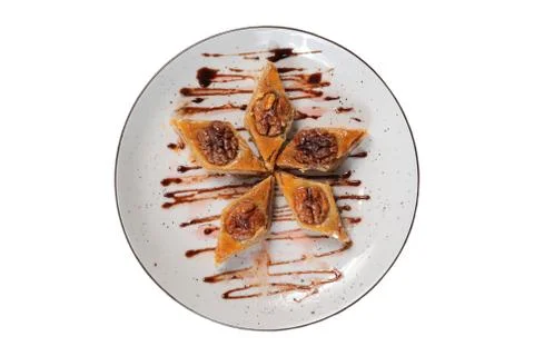 Oriental sweets with walnuts on white plate top view Stock Photos