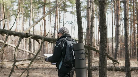 Orientation in a forest area with a map Video stock 104560574