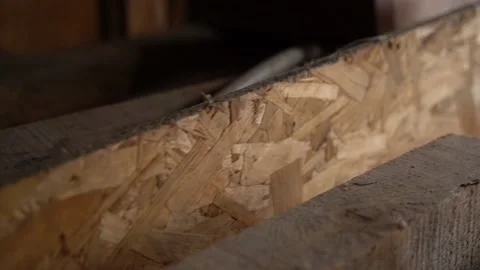 Oriented strand board close-up in a dark room. Camera movement along the osb Stock Footage 235421710