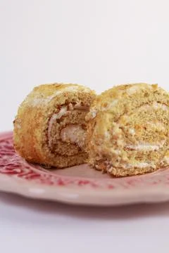 Oriented Swiss roll cake slice, emphasizing its tight spiral of tender sponge Stock Photos