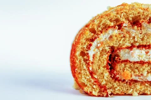 Oriented Swiss roll cake slice, emphasizing its tight spiral of tender sponge Stock Photos
