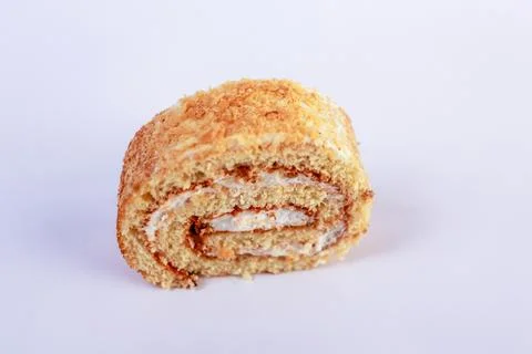 Oriented Swiss roll cake slice, emphasizing its tight spiral of tender sponge Stock Photos