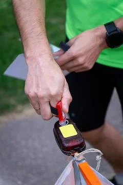 An orienteering athlete using an electronic timing punch Fotos Stock