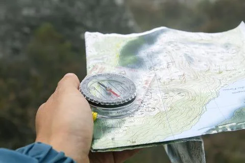 Orienteering with compass and topographic map Stock Photos