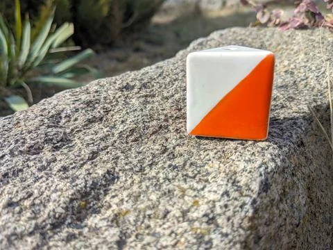 Orienteering control point prism marker on stone surface in outdoor natural Stock Photos