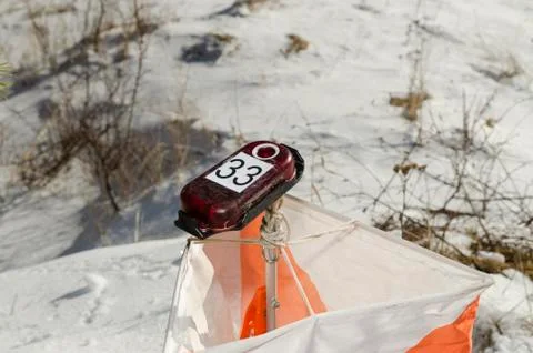 Orienteering control point in a snow field Stock Photos