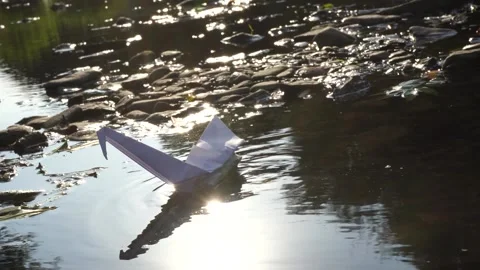 Origami floats in the river. Stock Footage 228844998