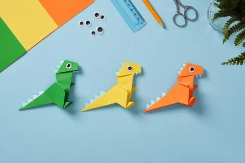 Origami work table with sheets of paper, googly eyes, scissors, ruler, and .. Stock Photos