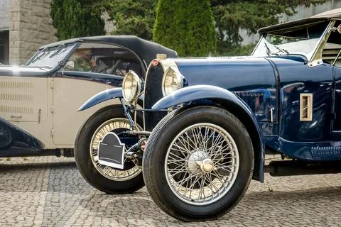 Original dark blue Bugatti Type 40 on cobblestone drive on sunny day Stock Photos