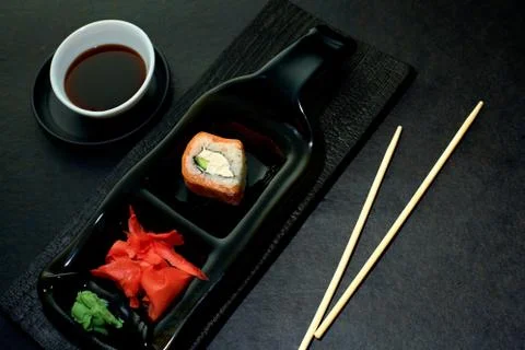 The original idea of serving sushi rolls in a restaurant. Sushi roll, ginger, Stock Photos