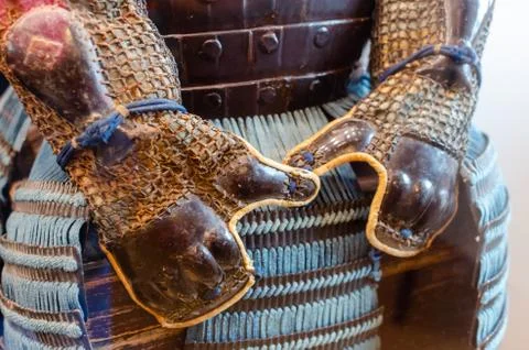 Original medieval japanese samurai armor (yoroi) in the museum. Hands protect Stock Photos