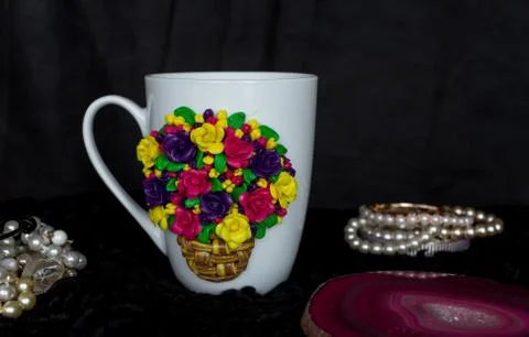 The original mug with decorative figurines made with their own hands. A lovely Stock Photos