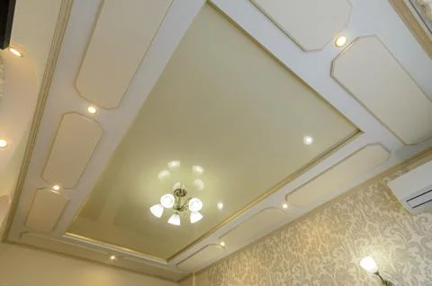 Original multi-level stretch ceiling with plasterboard elements in the bedroo Stock Photos