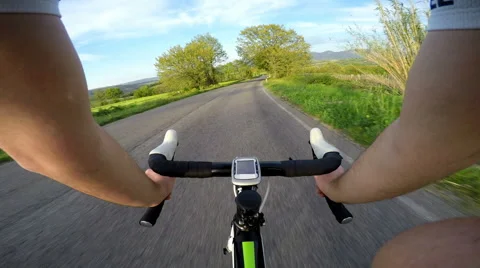 Original point of view, POV. Young man cyclist on road bike in Italy at sunset. Video stock 55667090