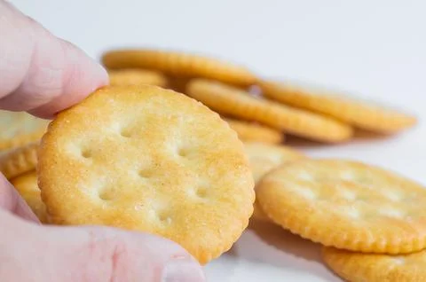 Original Ritz crackers in hand. Close-up. Stock Photos