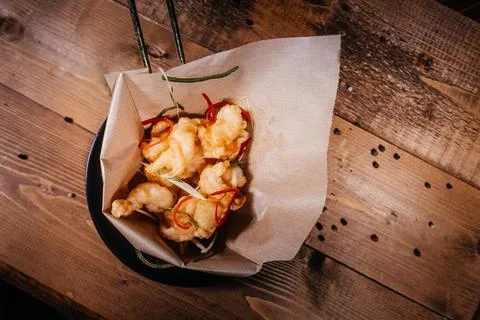 An original top-down perspective featuring battered fried shrimp with chili p Stock Photos