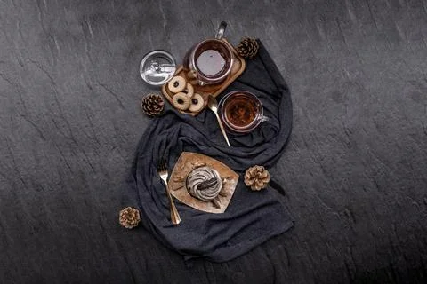 Orio cupcake with a cup of Fruit tea on a deep blue fabric. Stock Photos