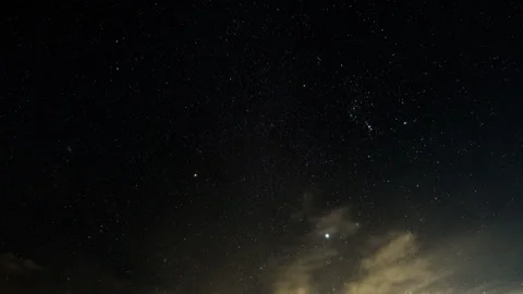Orion Rises From Blue Sky through Clouds and Dark Blue Sky Stock Footage 282554512