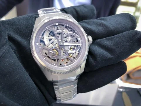 Oris scelleton watch in hand wearing gloves close up Stock Photos
