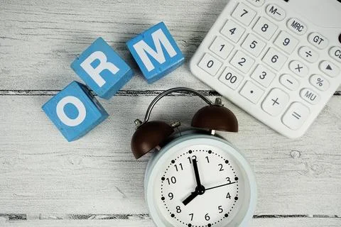 ORM (Operational Risk Management) text with alarm clock and calculator on w.. Photos